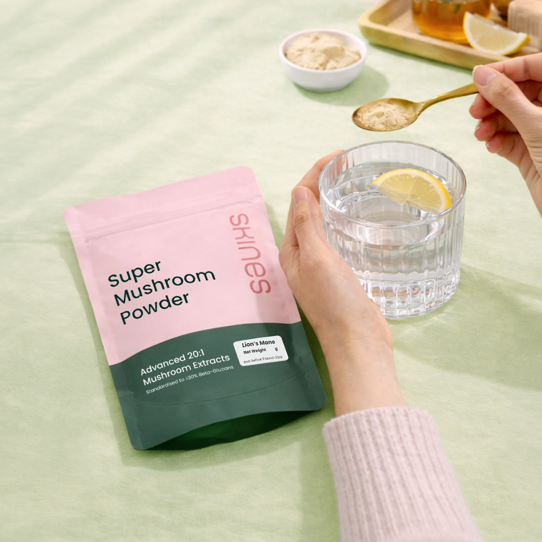 Super Mushroom Powder package with a glass of water and lemon on a light green background | SKINES
