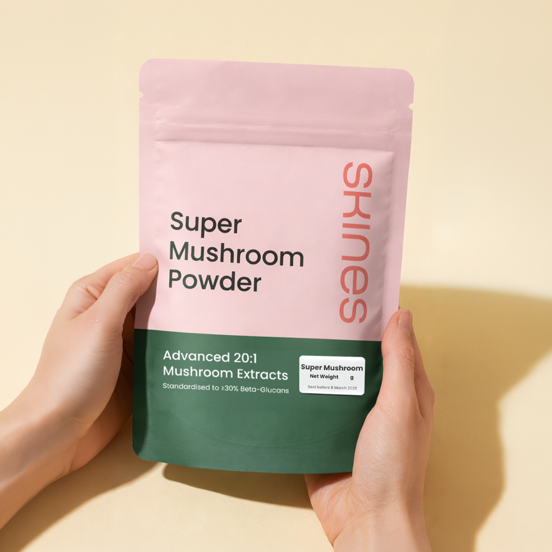 Hand holding a package of 'Super Mushroom Powder' by Skines