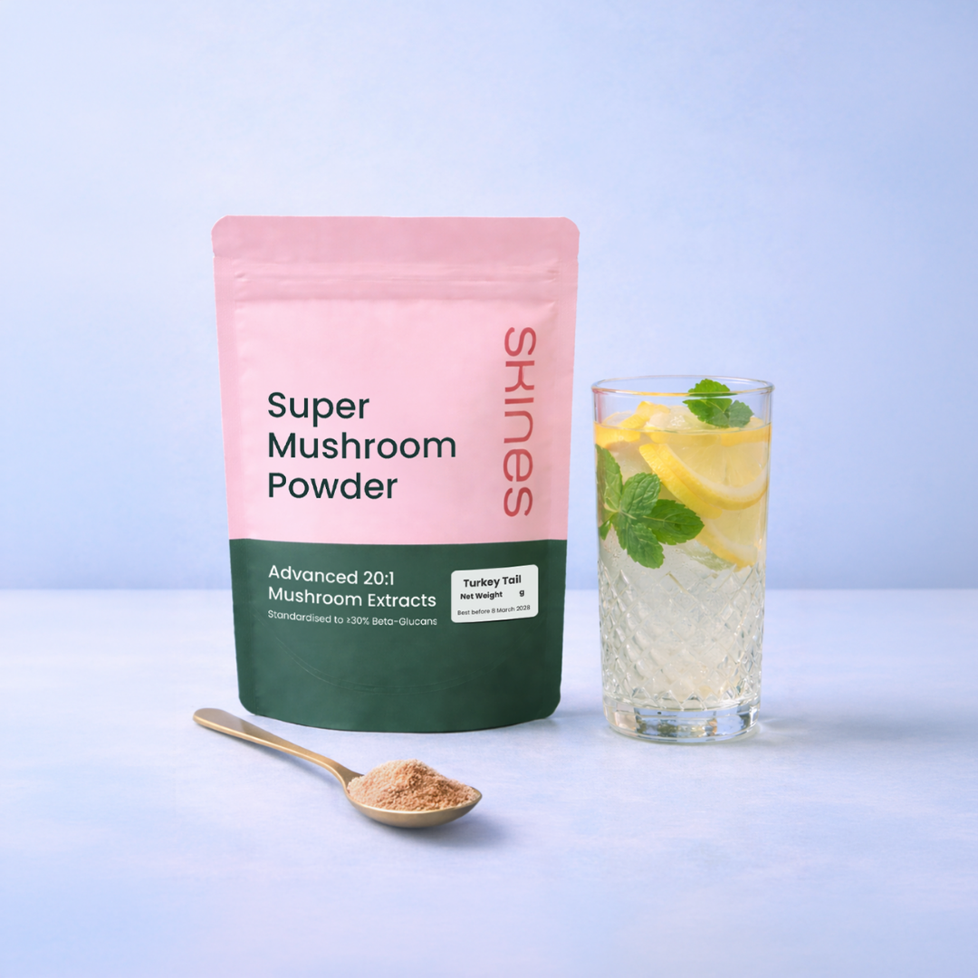 Super Mushroom Powder package with a glass of lemon water on a light blue background